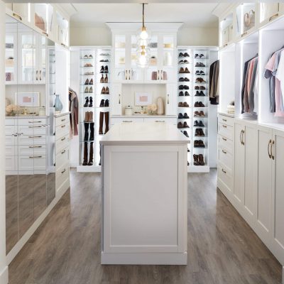 Custom white boutique closet with island and mirrors from Inspired Closets