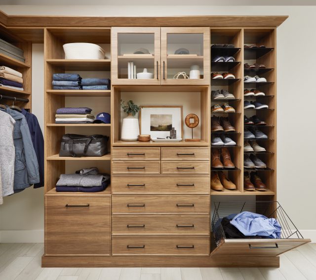 Walk in closet with storage for men's closet, custom shoe shrine shelves and pull out hamper.
