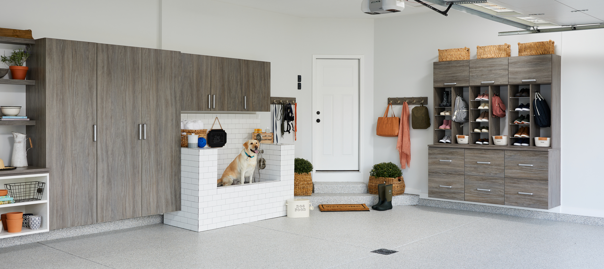 Custom garage entryway storage with large cabinets from Inspired Closets