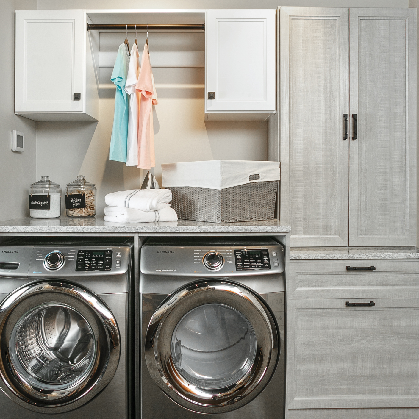 Laundry room storage solutions with hanging rod from Inspired closets