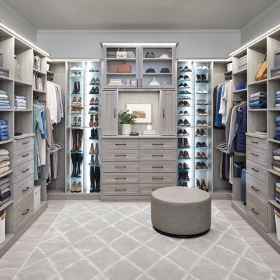 Large custom closet with new custom lighting and adjustable shoe shelves in timber grey