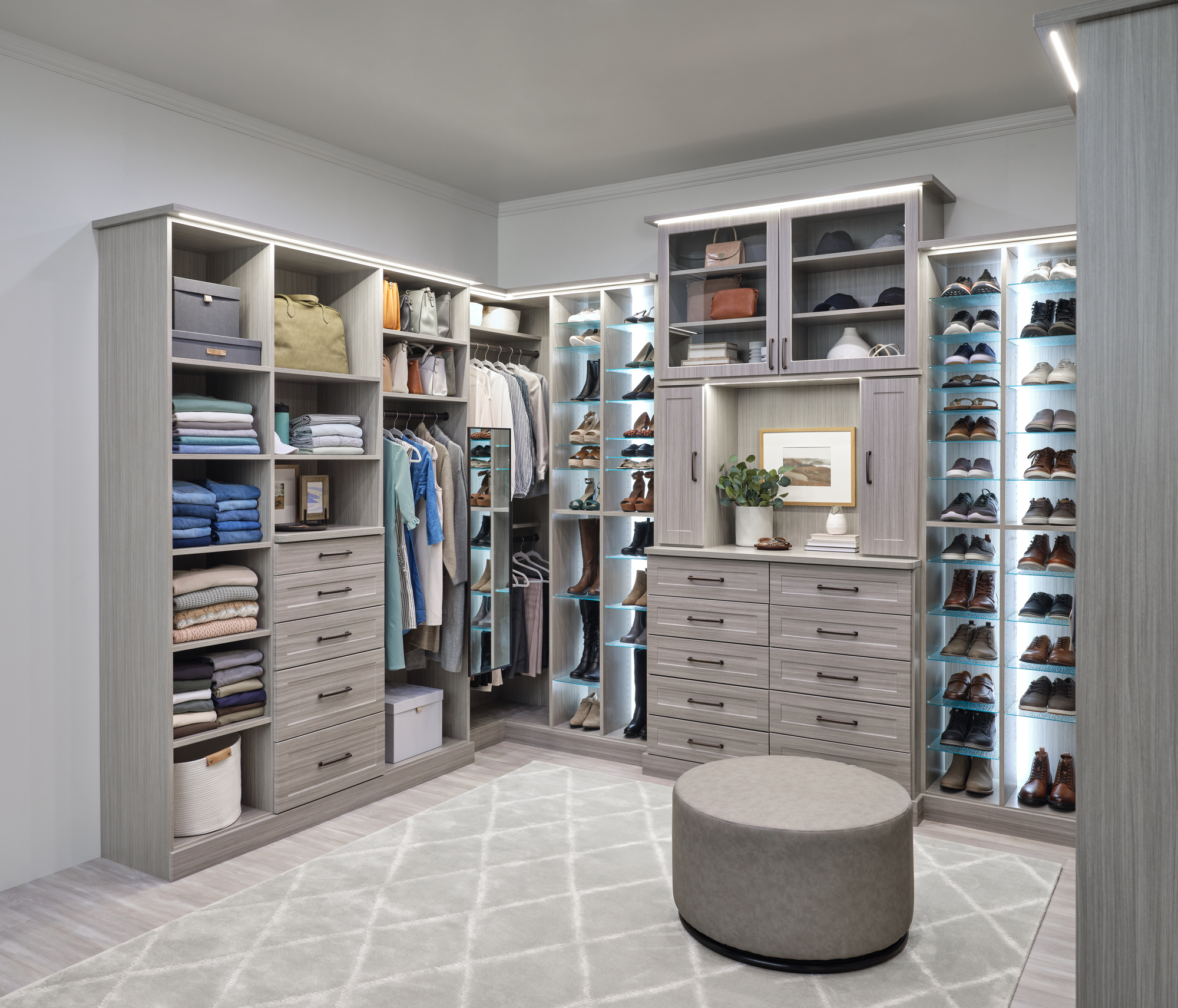 Large custom closet with custom lighting, shelving and adjustable shoe shelves in timber grey