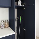 Utility storage for a navy blue laundry room from Inspired Closets