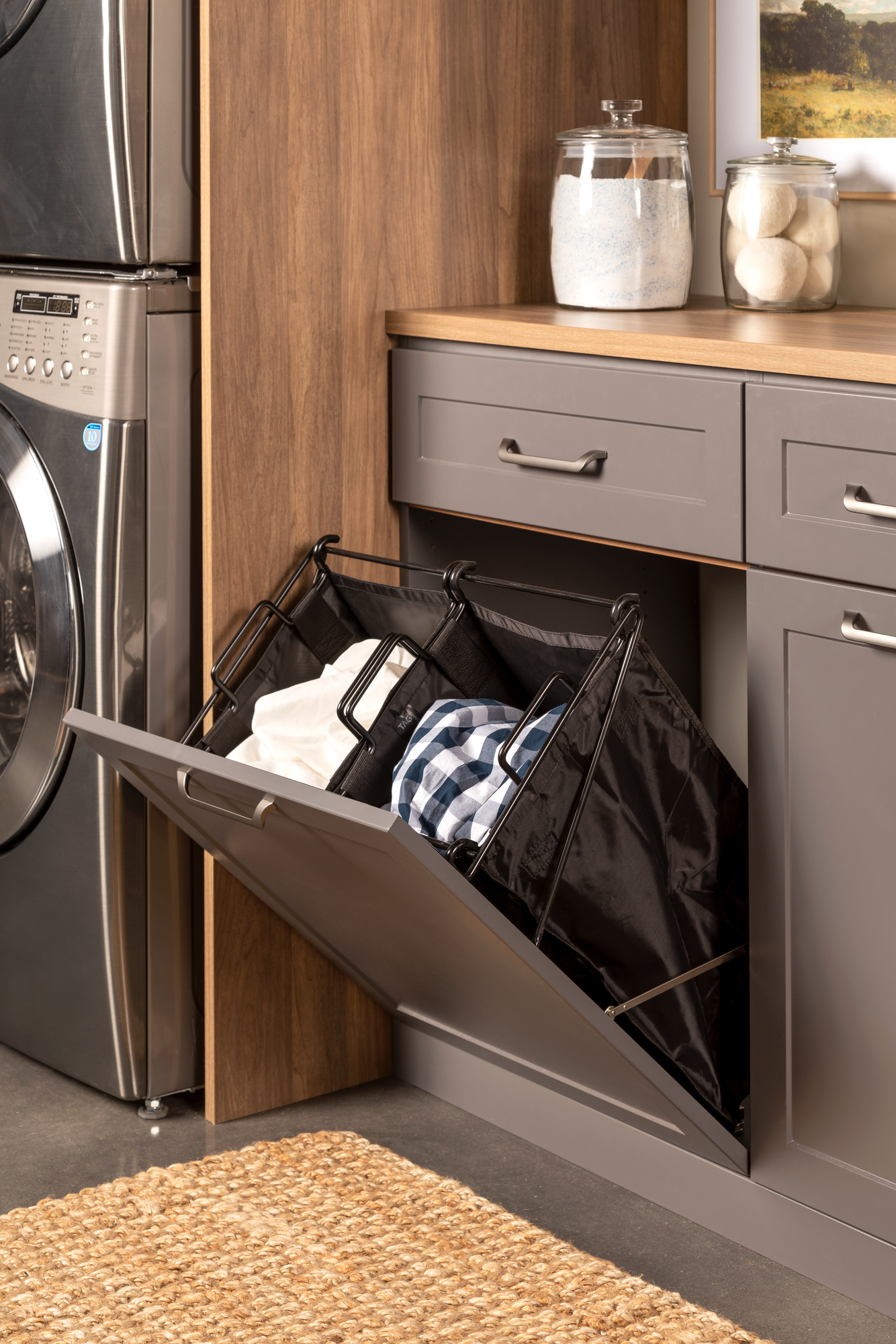Tilt out hamper for a laundry room mudroom combo from Inspired Closets