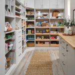 Walk-in gally pantry with pull out drawers, counter space and closed storage