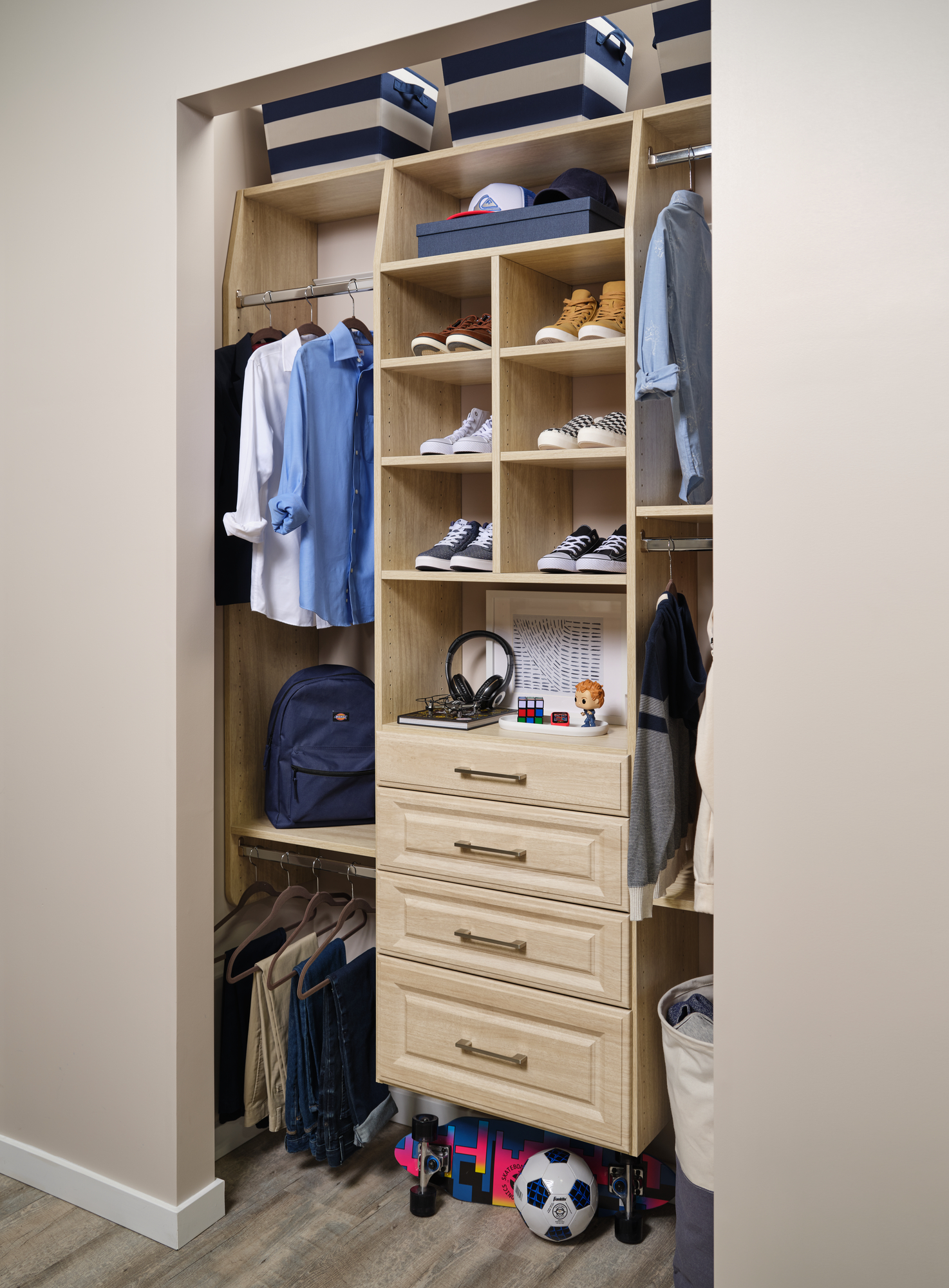 Young boys walk in closet with drawers and shoe storage from Inspired Closets