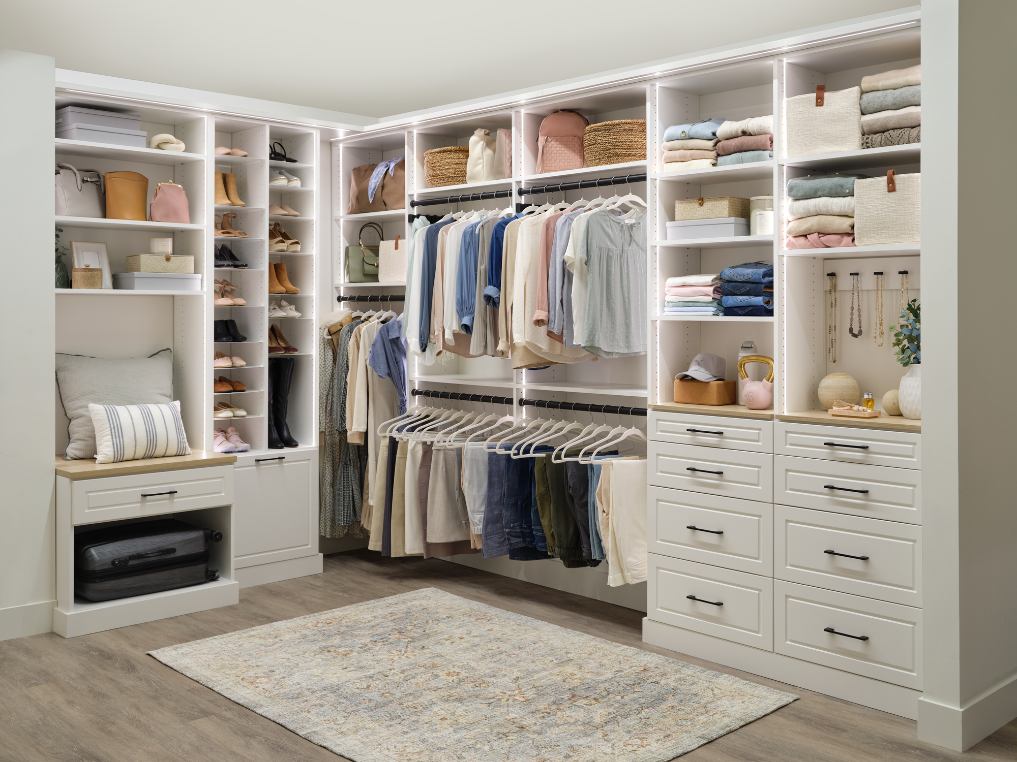 White women's walk-in closet with mood changing lighting from Inspired Closets