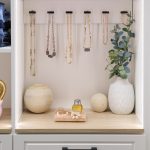 Unique storage for necklaces in a white walk-in closet from Inspired Closets