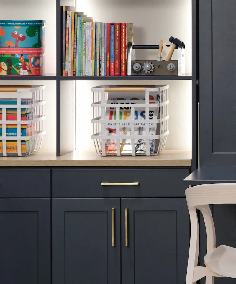 Navy shelving storage with bins and light to see into the corners from Inspired Closets