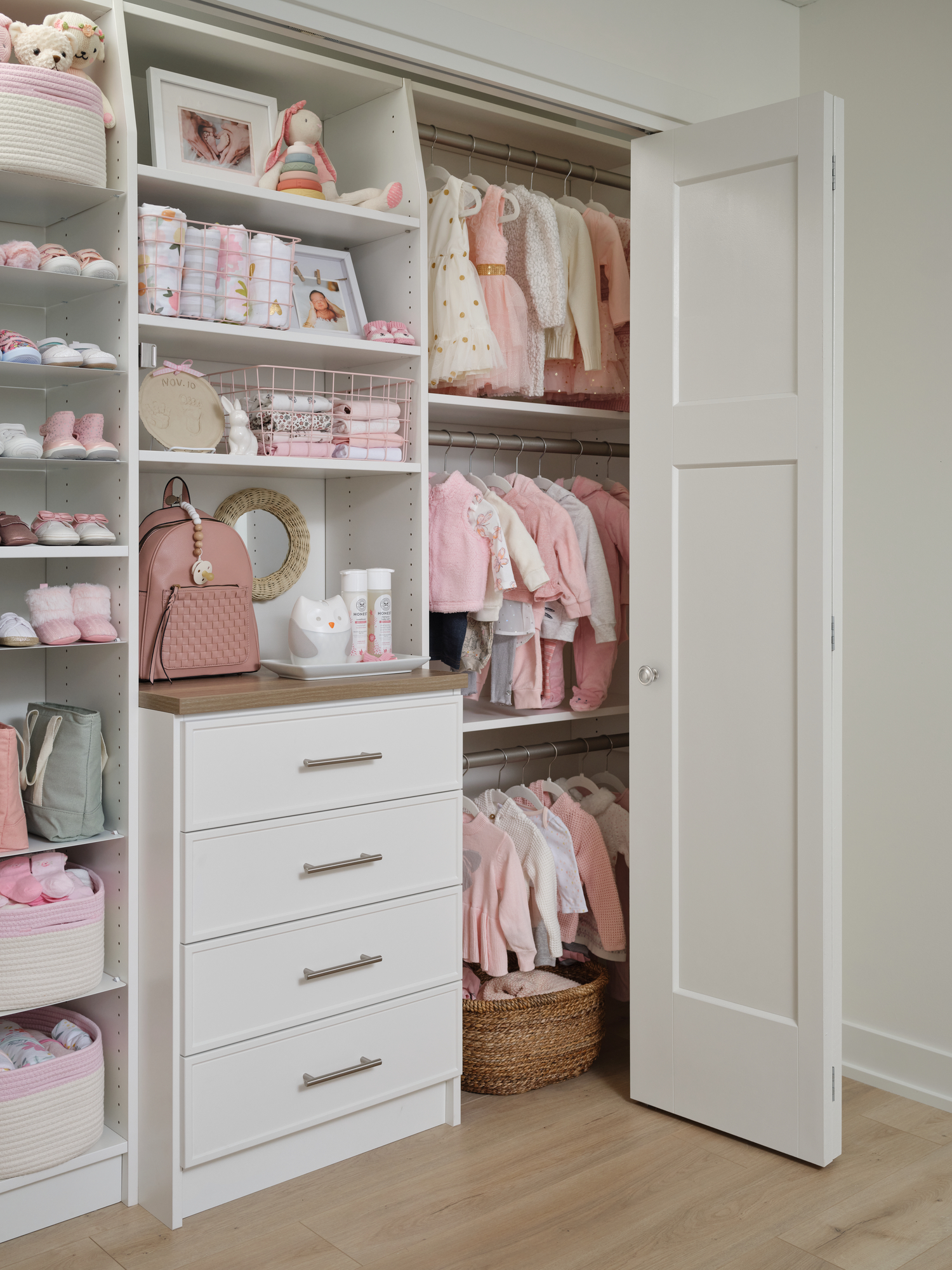 White little girls closet with basket and hanging storage from Inspired Closets