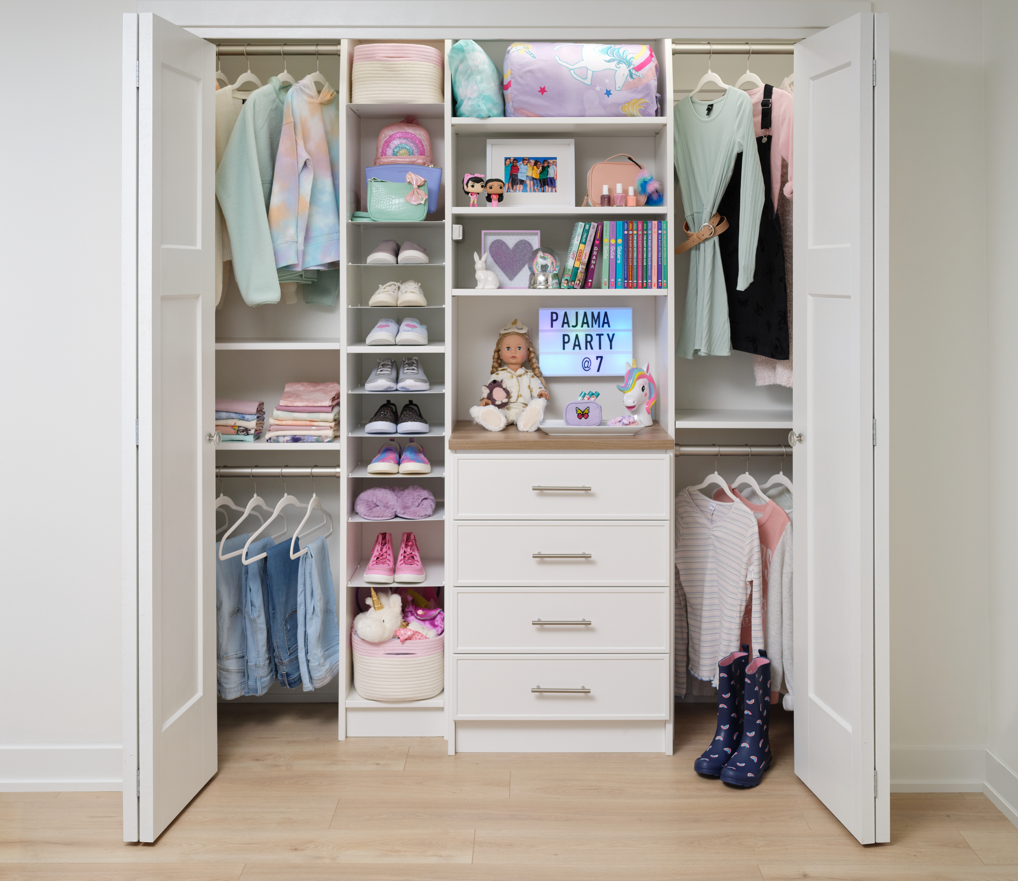 Girls white closet organizer with dress and shirt hanging storage