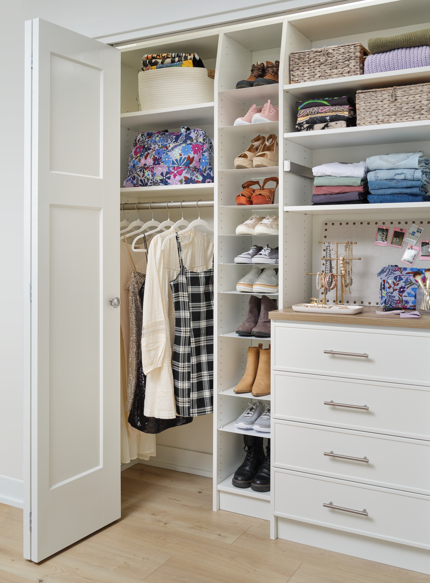 White reach-in closet with storage for baskets from Inspired Closets