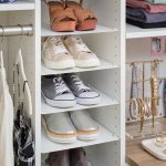 Adjustable shoe storage in white closet by Inspired Closets