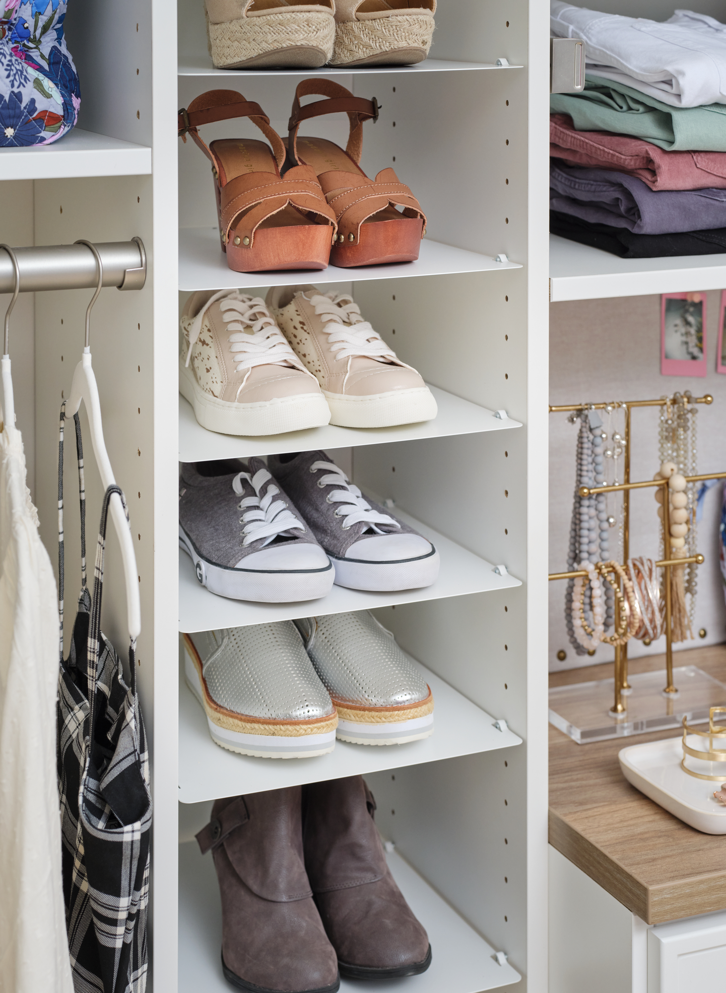 Adjustable shoe storage in white closet by Inspired Closets