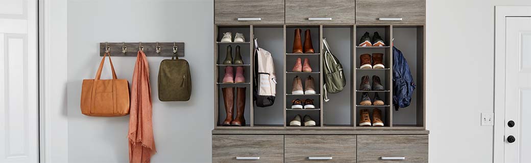A shoe storage system with coat hooks to the side.