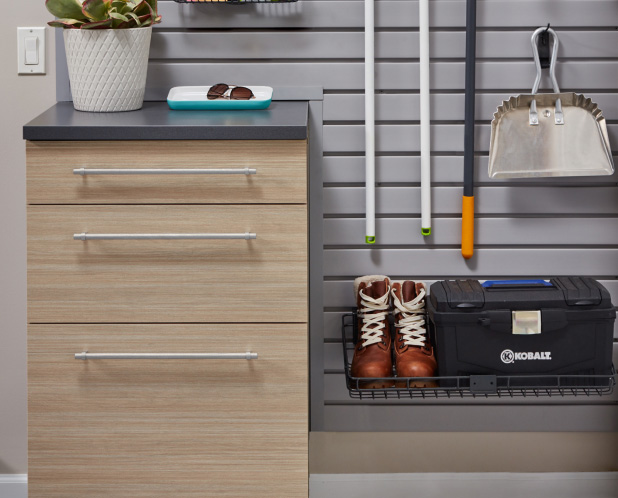 A shelf with shoes and tool box surround by tools.