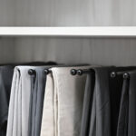 Men's pants storage hanging in boutique closet