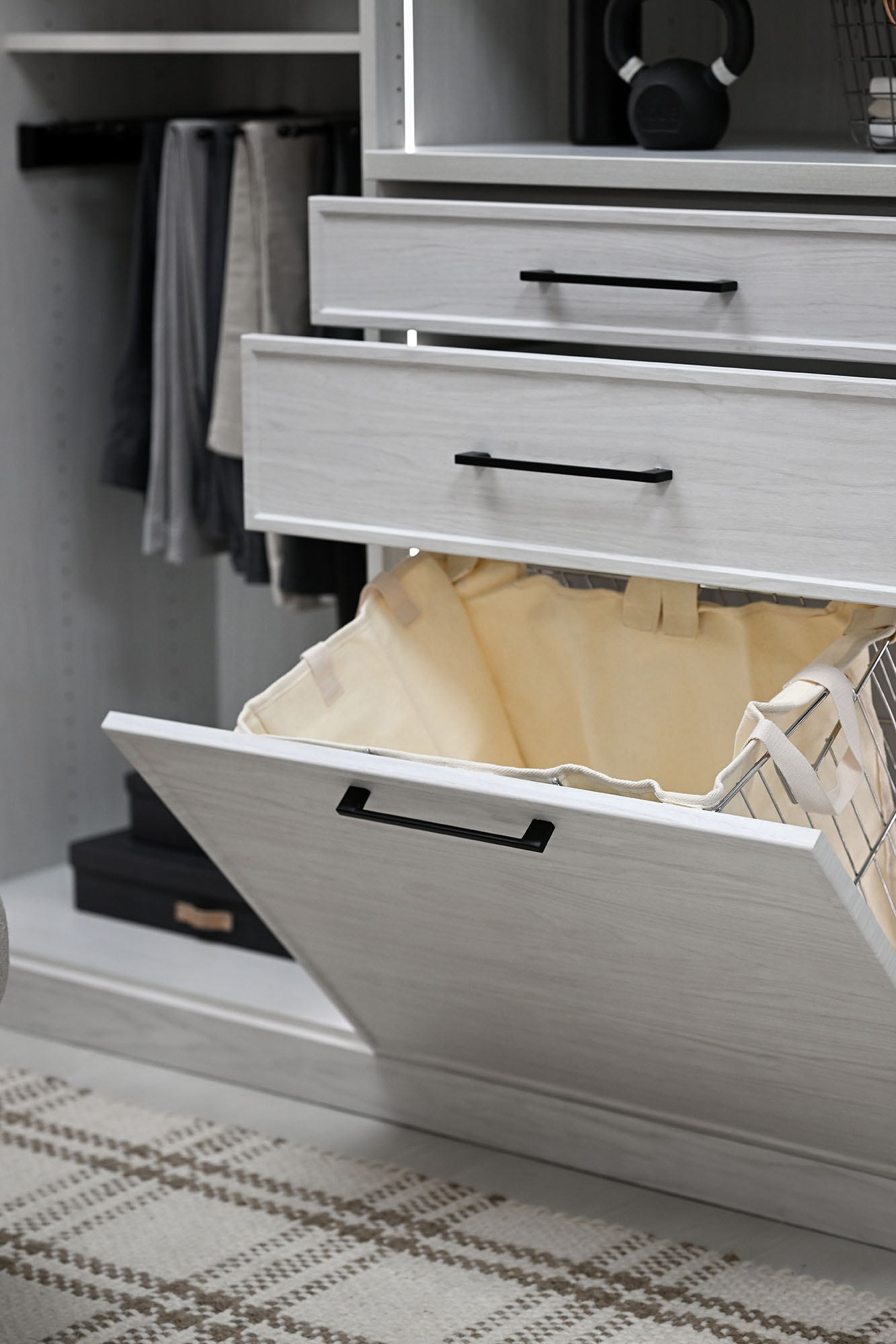 Laundry hamper storage in boutique closet