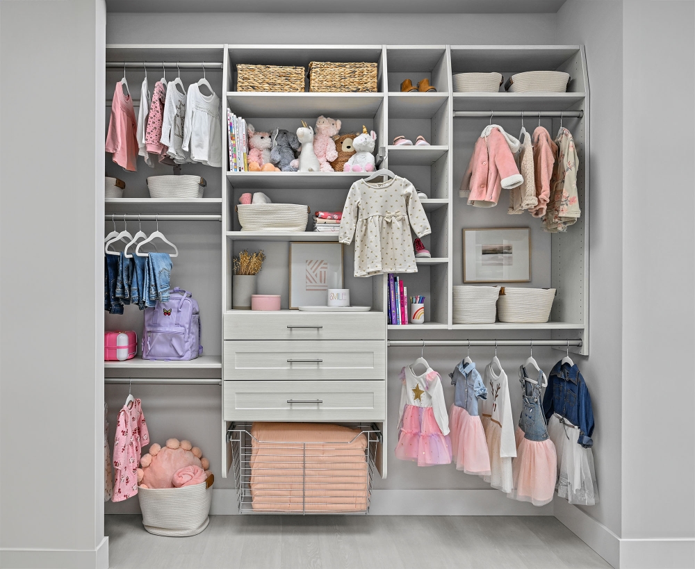 Kid's closet with hanging, shelves, drawers, and wire basket