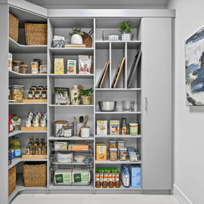 Pantry organized with wire baskets, shelves, and cabinets