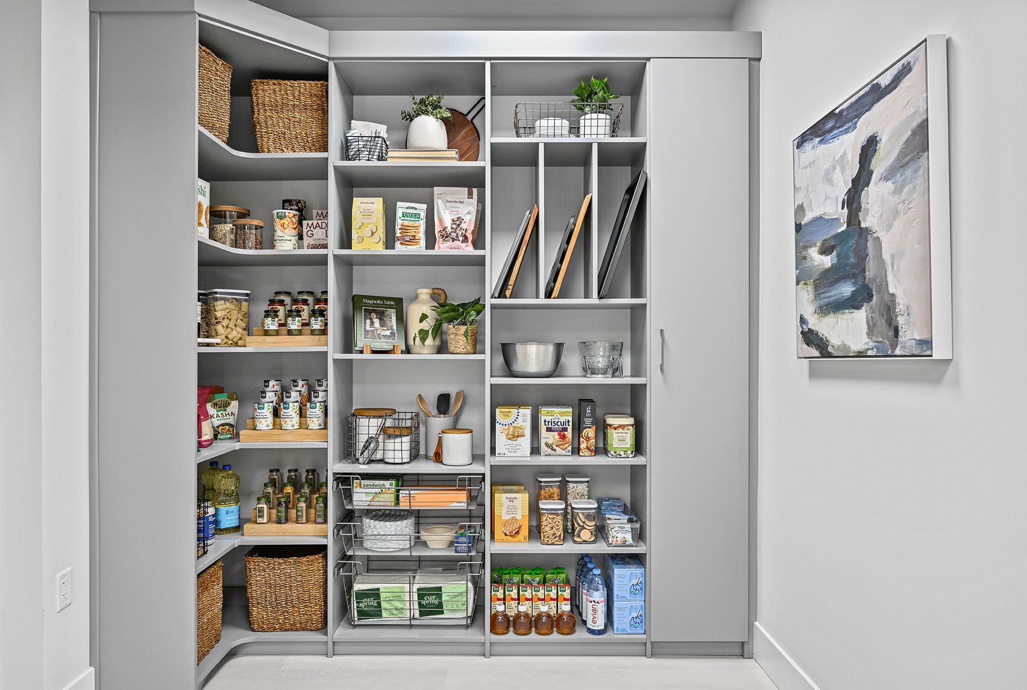 Pantry organized with wire baskets, shelves, and cabinets