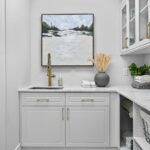 Laundry room in artic white with matte brass hardware