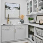 Laundry area with matte brass hardware and lots of storage