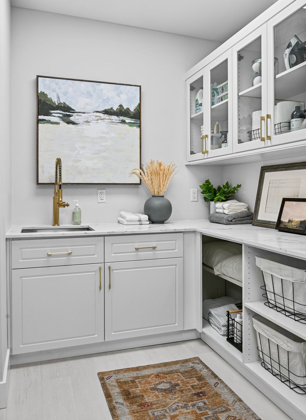 Laundry area with matte brass hardware and lots of storage