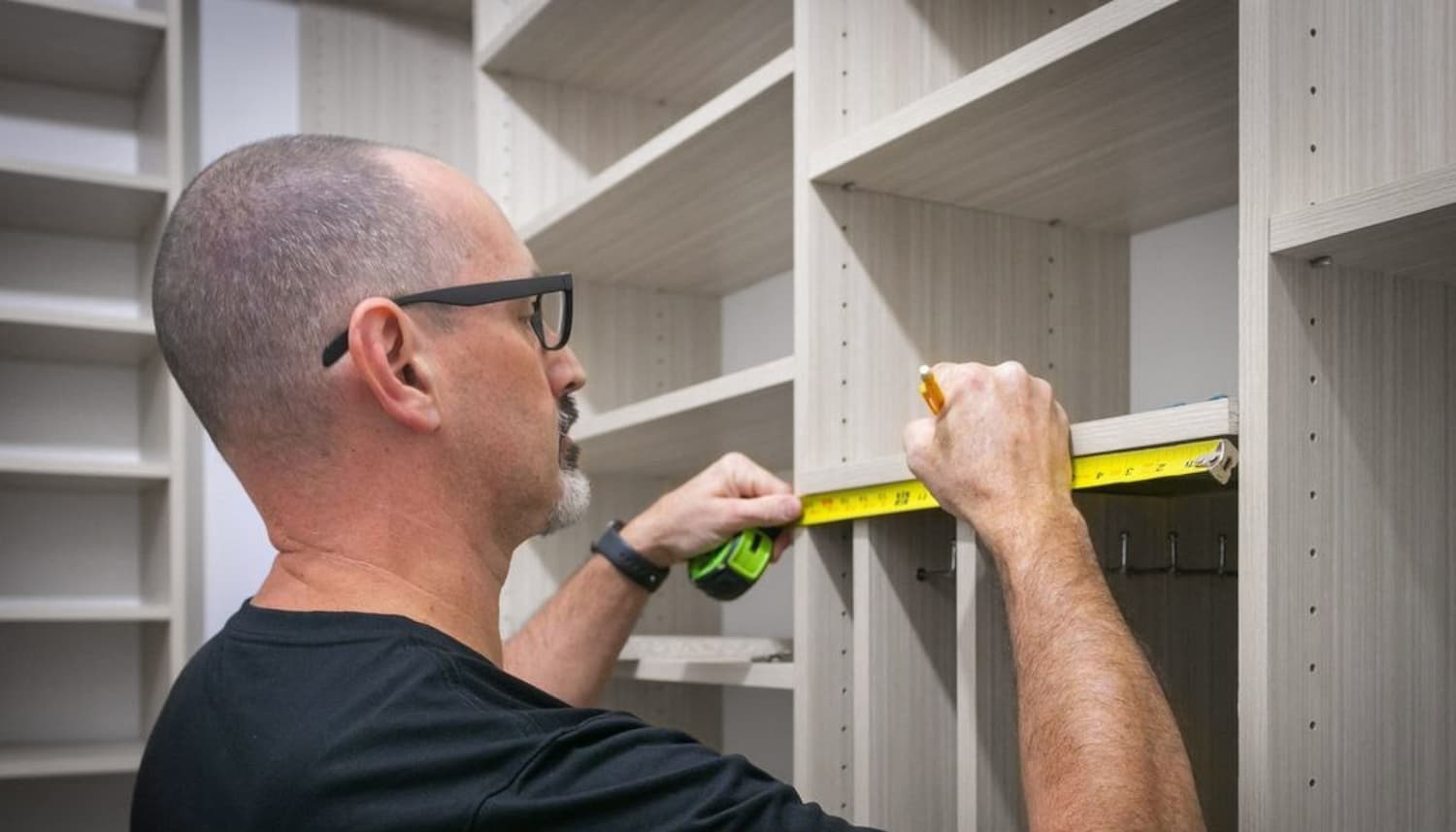 Man Measuring Shelf