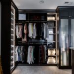 Organized jeans, tops, bottoms, and purses in an Inspired Closets boutique closet.