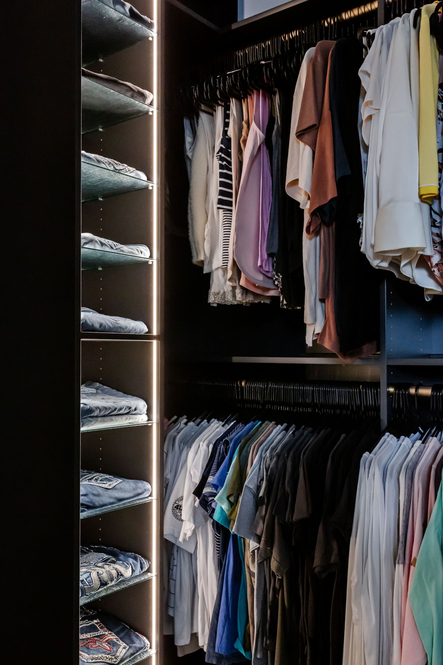 Integrated lighting illuminates an Inspired Closets boutique closet.