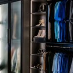 Glass doors create a beautiful display in this Inspired Closets boutique closet.