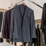 Pull-down hanging bar for suit jackets in an Inspired Closets boutique closet.
