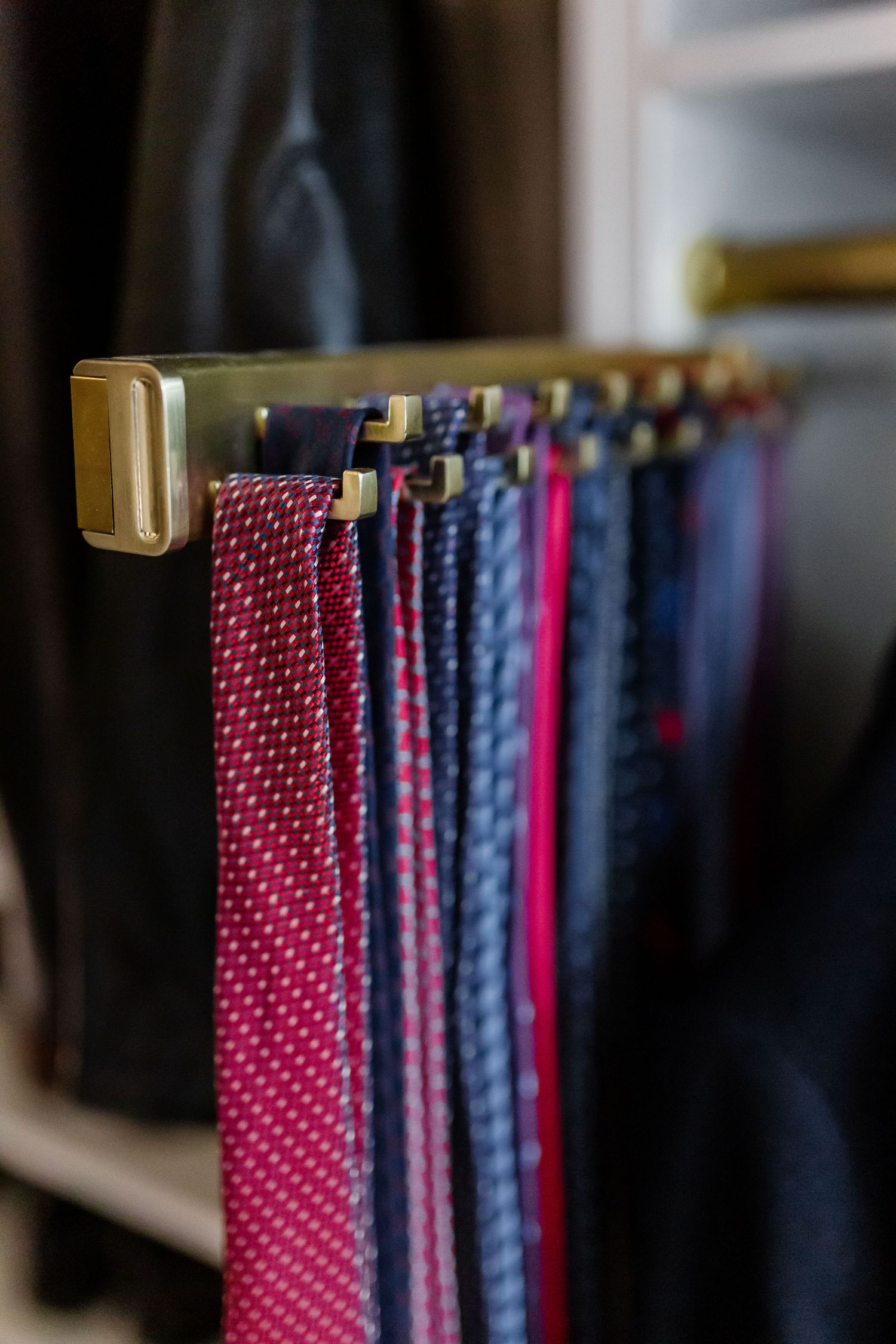 Matte brass pull-out tie rack.
