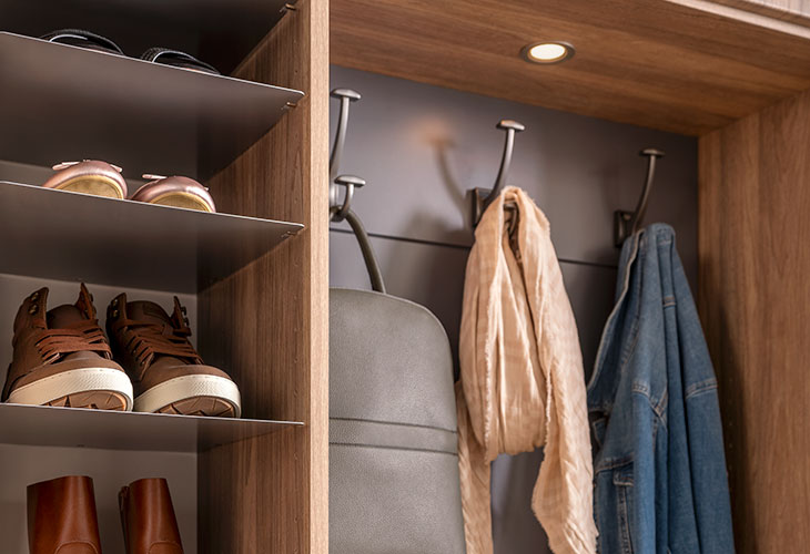 Closet showing shoe collection and clothes hangers