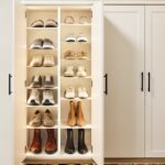 Entryway 5 Custom entryway with glass-front cabinets above and locker-style cabinets below for shoe, firewood, and miscellaneous storage in a warm white finish with matte black hardware