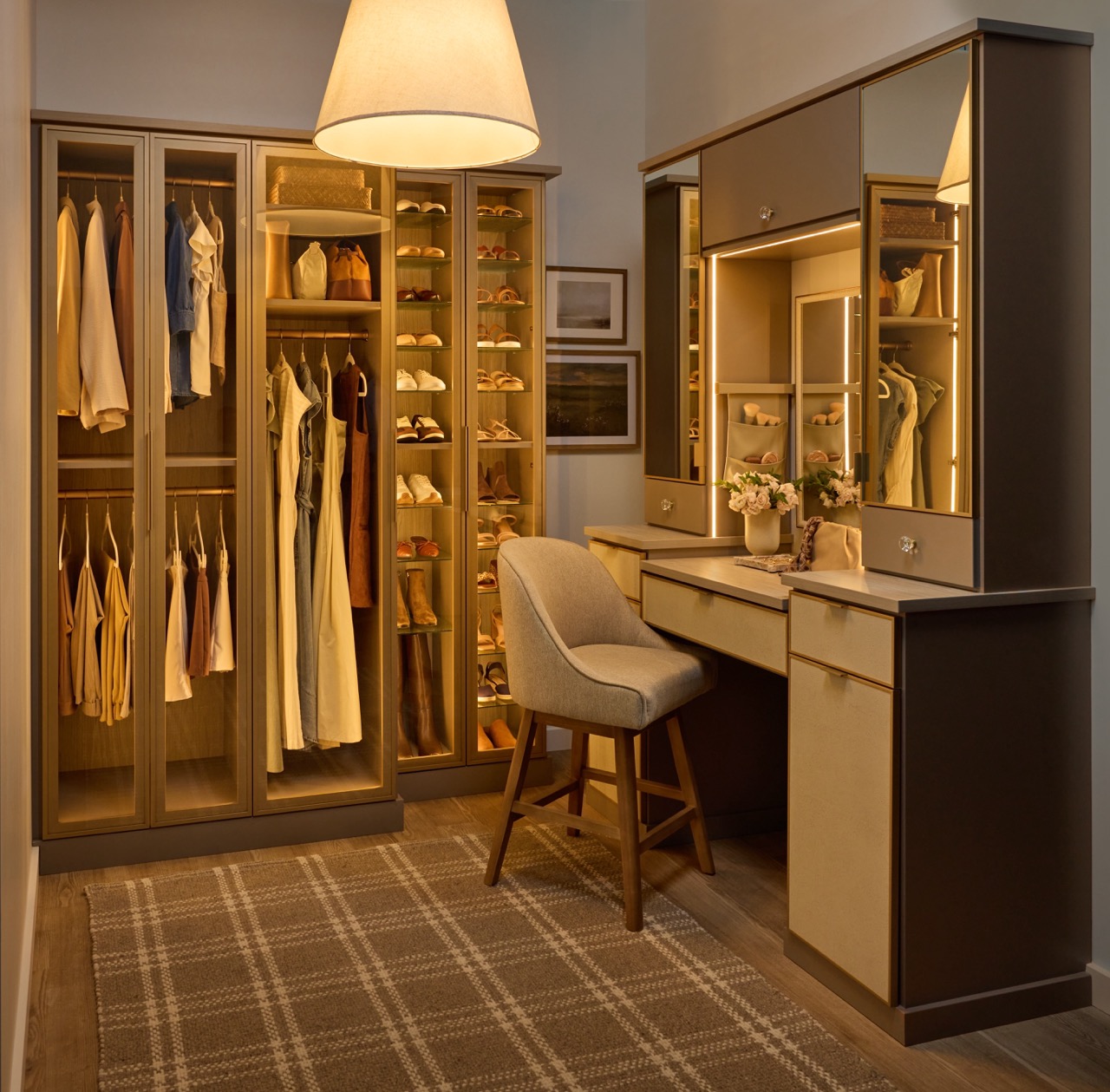 Her custom closet with glass-front cabinets for clothes and shoe organization, and a vanity with soft-close drawers, integrated lighting, mirrored door fronts, leather drawer fronts, and matte brass and gold accents