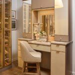 Custom vanity with soft-close drawers, integrated lighting, mirrored door fronts, leather drawer fronts, and matte brass and gold accents