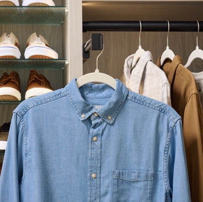 An extended valet rod holding a man's shirt