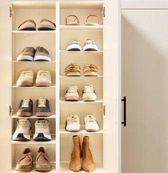 Entryway Shoe Shrine A Shoe Shrine with a variety of shoes behind cabinet doors in a white entryway