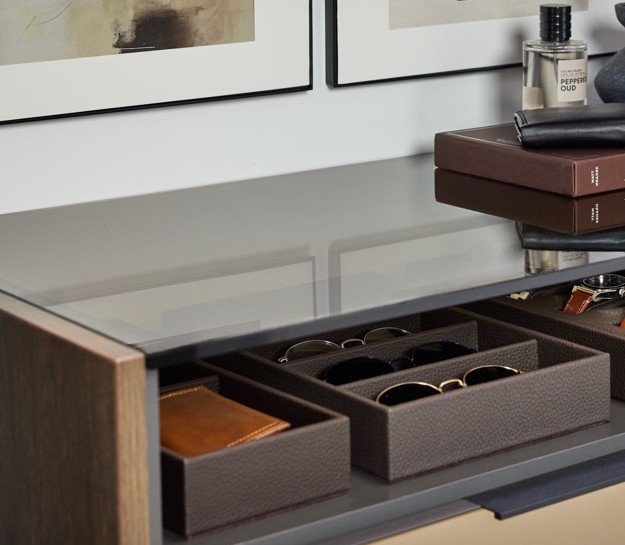 An Elusion top over open storage in a man's closet