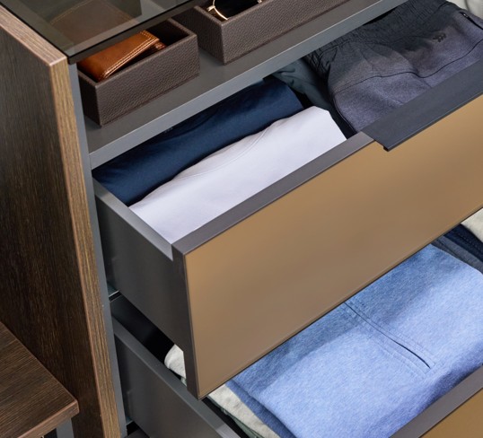 Soft-close drawers holding a variety of folded men's clothes